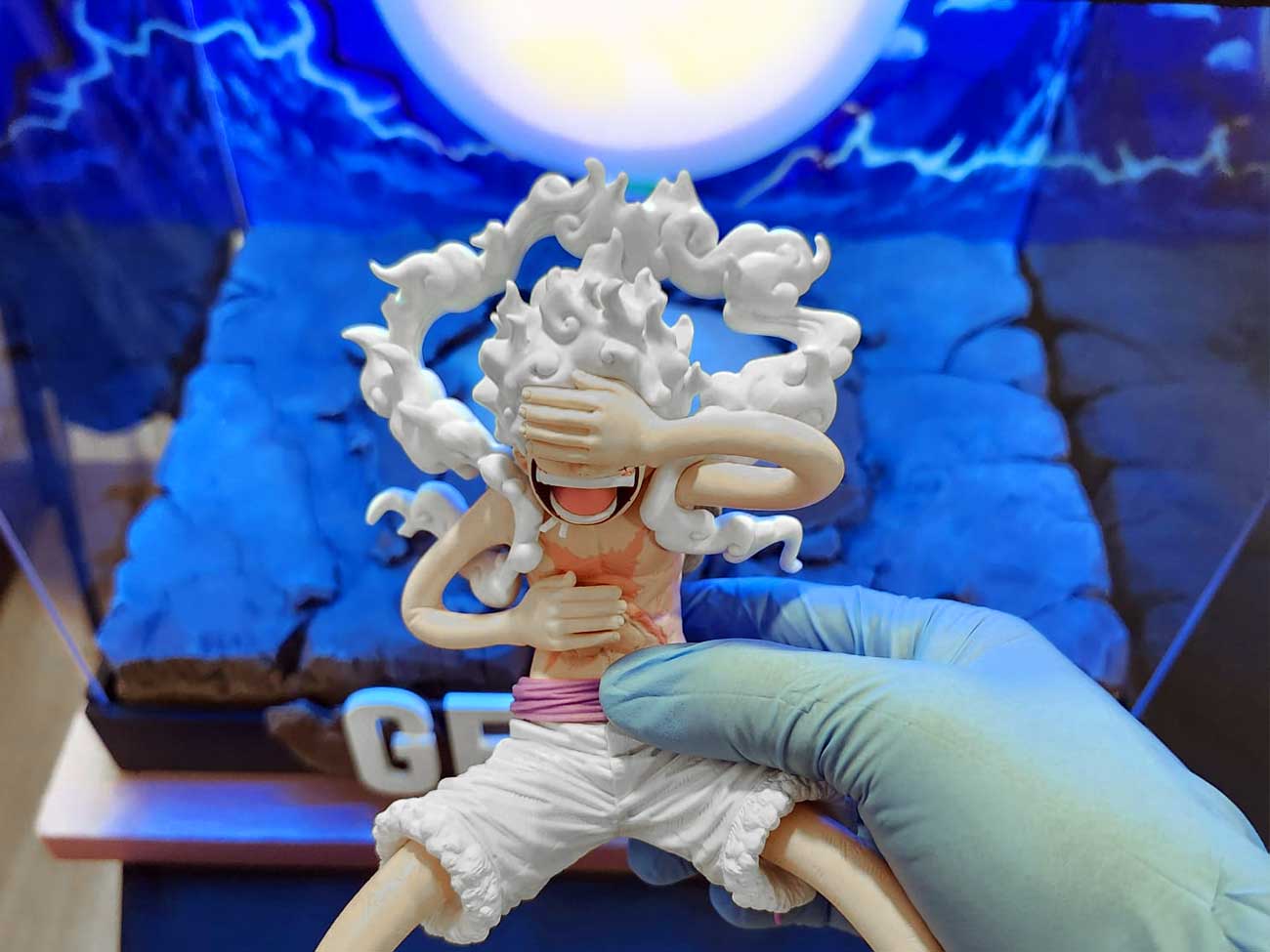 Bringing-Every-Element-Together10 Positioning the Gear 5 Luffy figure inside the handcrafted custom display case.